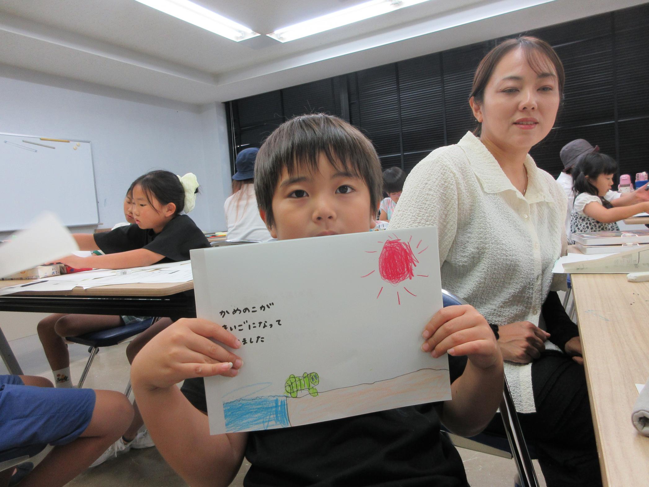 カメの絵本を見せてくれる参加者 カメの絵本を見せてくれる参加者
